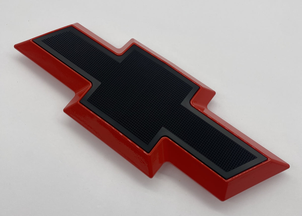 Front grille bowtie emblem for Chevy Silverado HD 2011-2014, red with black center, angled view